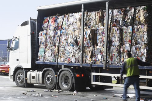 Recycling bins arranged for paper, glass, plastics and food waste at a business
