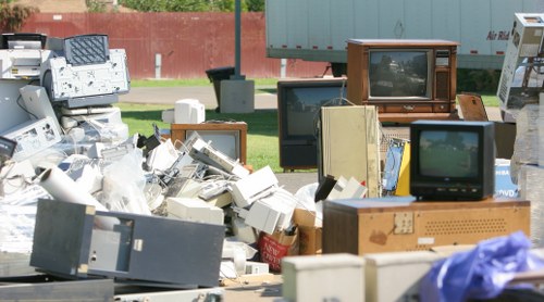 Modern equipment used for builders waste clearance in Honor Oak